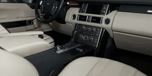 The interior of a Range Rover Evoque, with a cream and black interior.